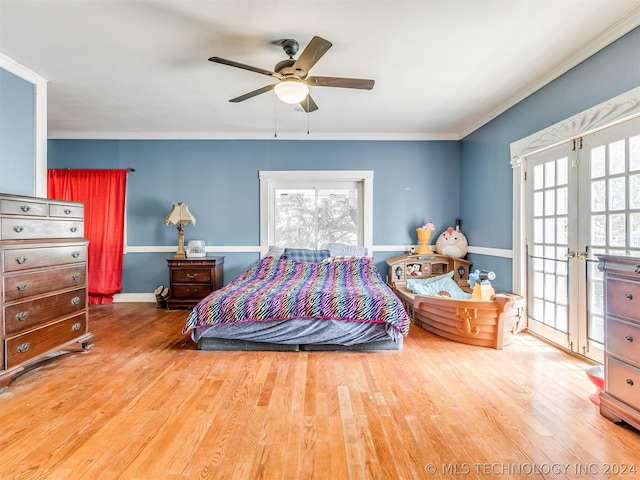 bedroom with hardwood / wood-style floors, ceiling fan, crown molding, and french doors