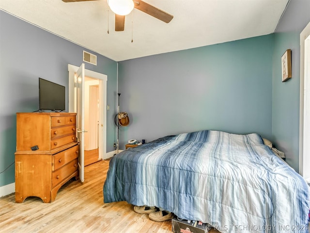 bedroom with hardwood / wood-style floors and ceiling fan