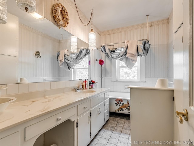 bathroom with a healthy amount of sunlight, oversized vanity, and tile flooring