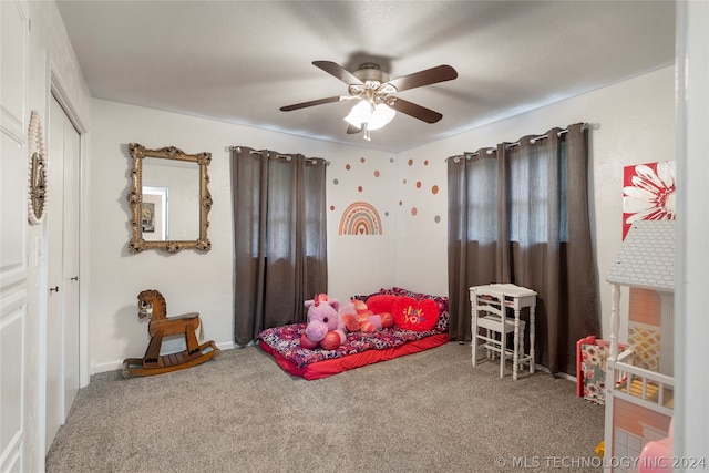 carpeted bedroom featuring a closet and ceiling fan