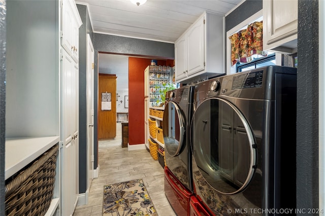 washroom featuring cabinets, light hardwood / wood-style floors, washer and clothes dryer, and crown molding