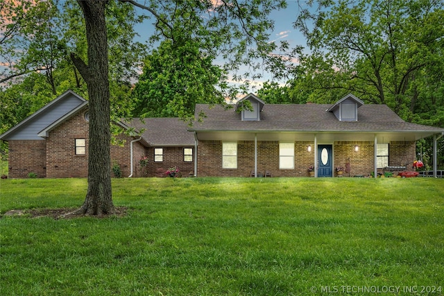 view of front of property featuring a yard and covered porch