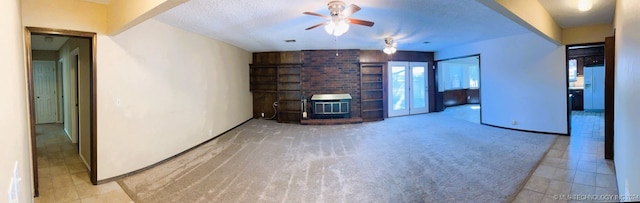 unfurnished living room with light carpet, a textured ceiling, and ceiling fan