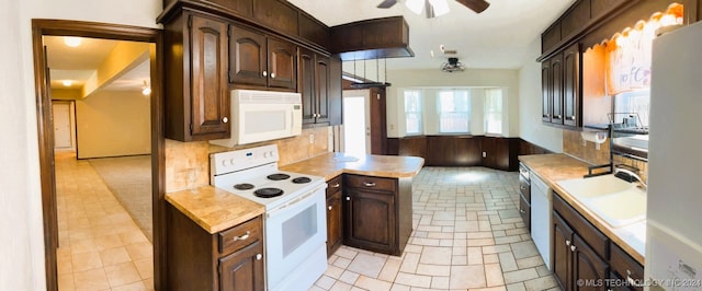 kitchen with ceiling fan, dark brown cabinets, sink, and white appliances