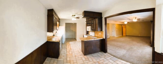 kitchen featuring electric range, dark brown cabinets, and ceiling fan