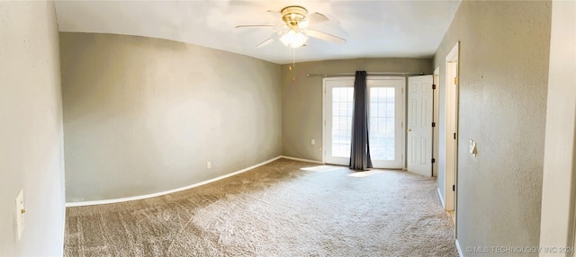 empty room featuring carpet floors and ceiling fan