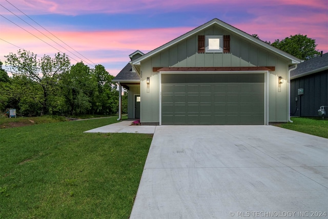 view of front of house with a yard and a garage