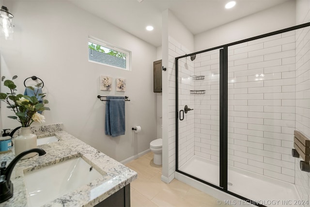 bathroom featuring walk in shower, double vanity, tile flooring, and toilet