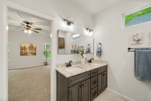 bathroom with ceiling fan and dual bowl vanity