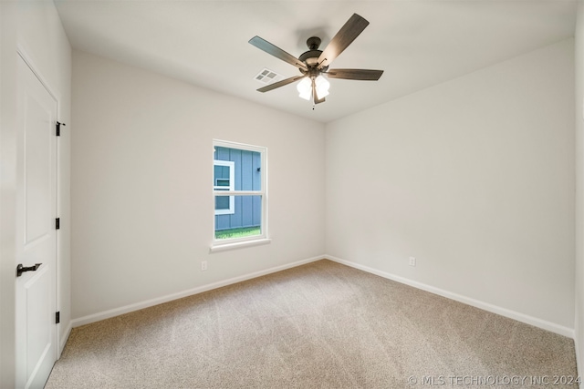 empty room featuring ceiling fan and carpet