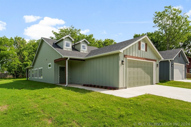 view of front of property featuring a garage and a front lawn