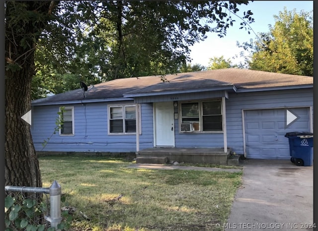 single story home featuring a garage, driveway, cooling unit, and a front yard