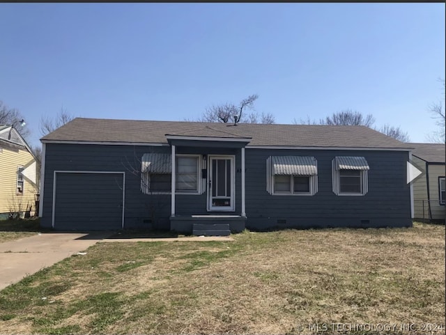 ranch-style home with a garage and a front lawn