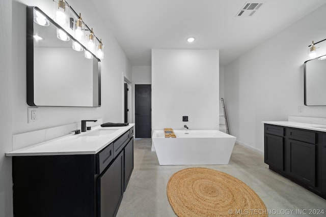 bathroom with vanity with extensive cabinet space, double sink, a bath to relax in, and concrete floors