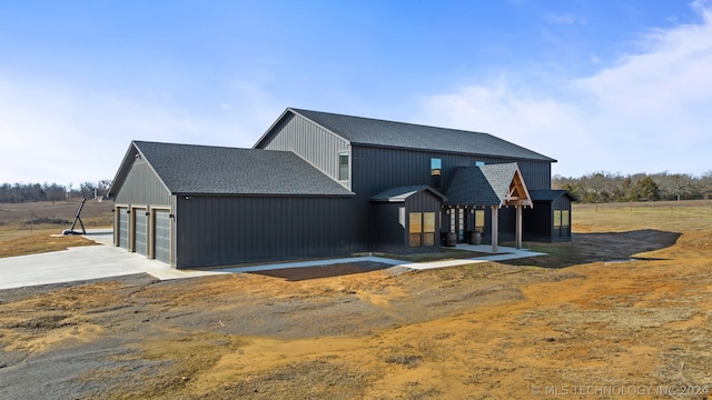 rear view of property featuring a garage