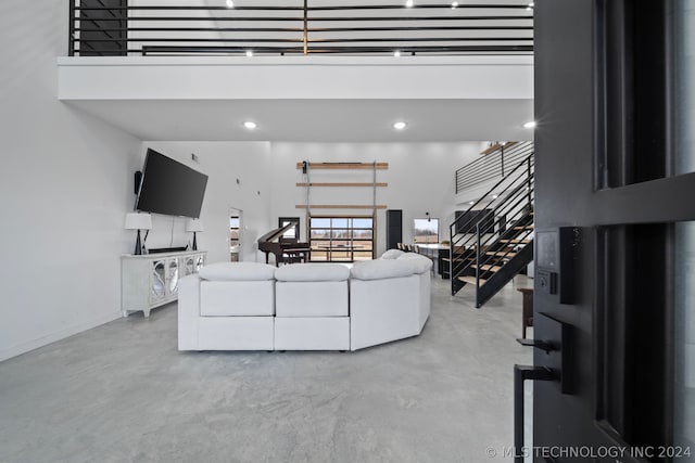 living room featuring a towering ceiling