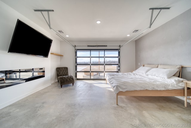 bedroom featuring concrete flooring