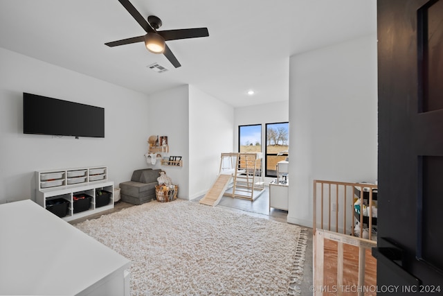 living room featuring ceiling fan and light wood-type flooring