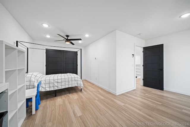 bedroom with light hardwood / wood-style floors and ceiling fan