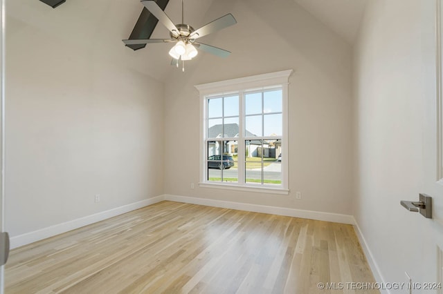 spare room featuring lofted ceiling, ceiling fan, and light hardwood / wood-style flooring