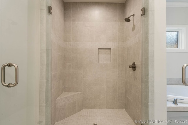 bathroom featuring independent shower and bath