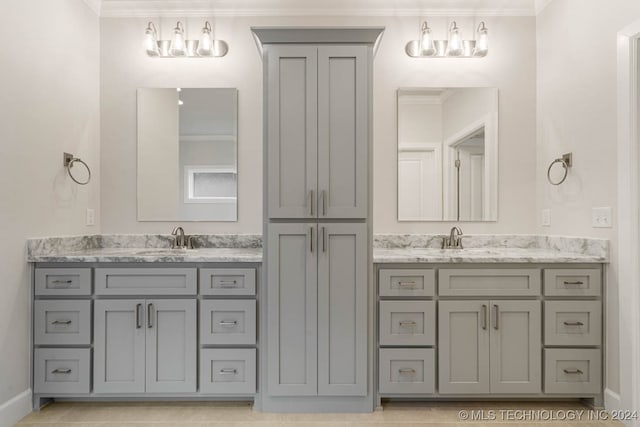 bathroom featuring vanity, crown molding, and tile patterned flooring