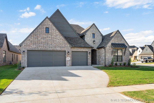 view of front of property featuring a garage and a front lawn