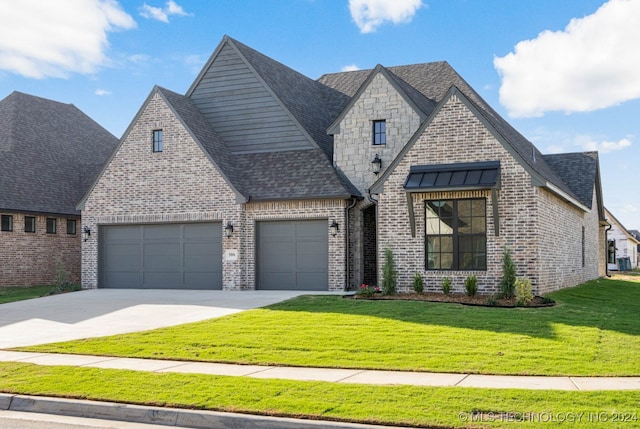 view of front of home with a front lawn and a garage