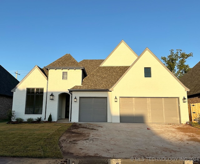 view of front of home with a garage and a front yard