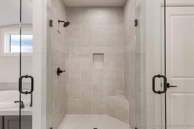 full bath with a bathtub and a shower stall