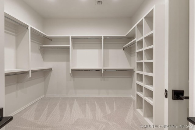 spacious closet featuring carpet and visible vents