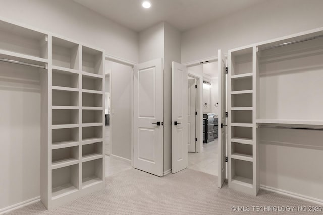 walk in closet with carpet