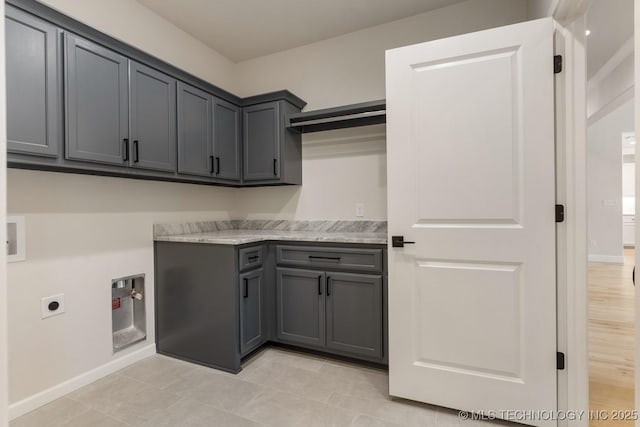 laundry area featuring cabinet space, baseboards, washer hookup, and hookup for an electric dryer