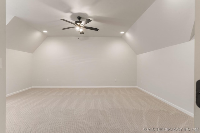 bonus room with light carpet, lofted ceiling, and baseboards