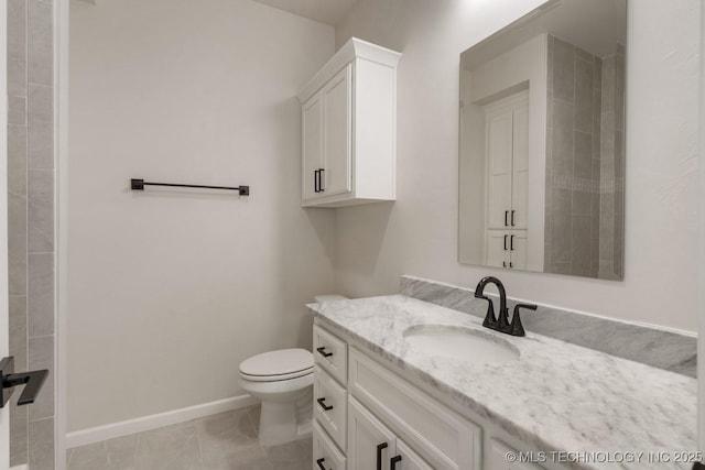 full bathroom featuring toilet, vanity, baseboards, and tile patterned floors