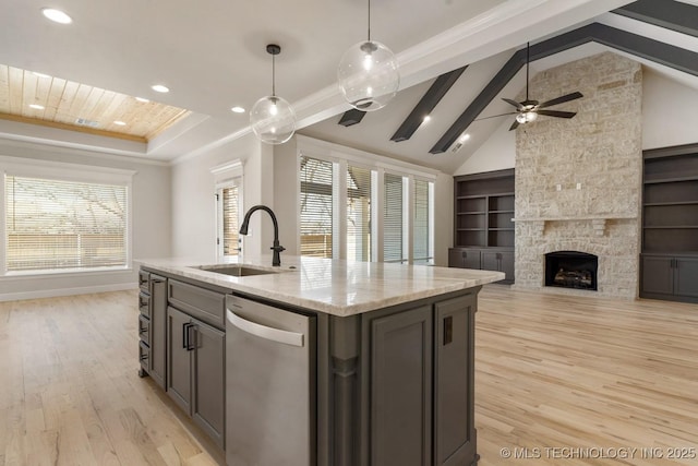 kitchen with dishwasher, open floor plan, decorative light fixtures, a kitchen island with sink, and a sink