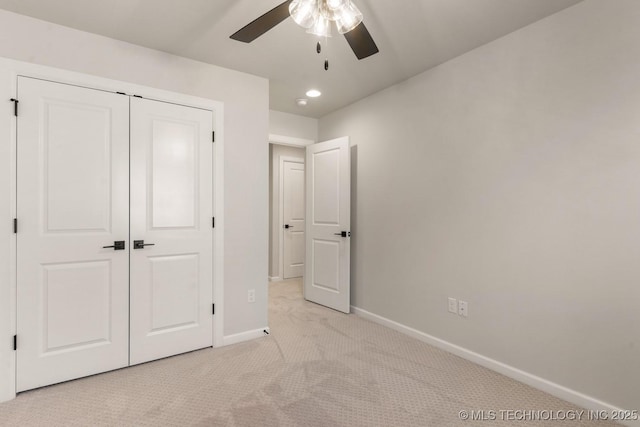 unfurnished bedroom with ceiling fan, recessed lighting, light colored carpet, baseboards, and a closet