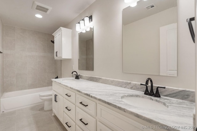 bathroom featuring toilet, shower / tub combination, visible vents, and a sink