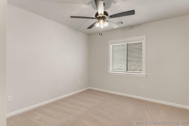 spare room featuring a ceiling fan, light carpet, visible vents, and baseboards