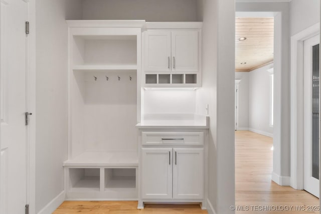 mudroom with light wood finished floors and baseboards