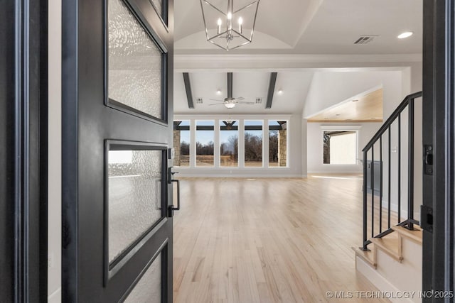 foyer featuring baseboards, stairway, vaulted ceiling with beams, light wood-style floors, and ceiling fan with notable chandelier