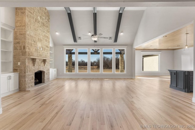 unfurnished living room with built in features, a fireplace, light wood-style flooring, high vaulted ceiling, and beamed ceiling