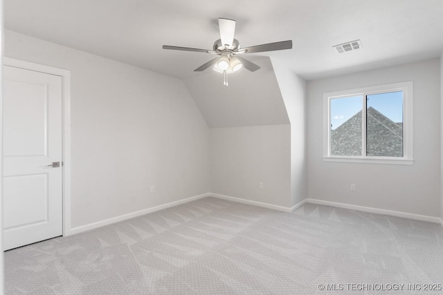 bonus room with lofted ceiling, carpet flooring, visible vents, and baseboards