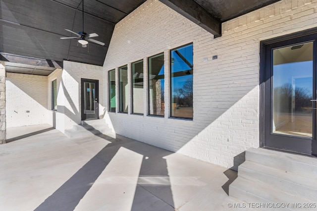 view of patio / terrace featuring a ceiling fan and entry steps