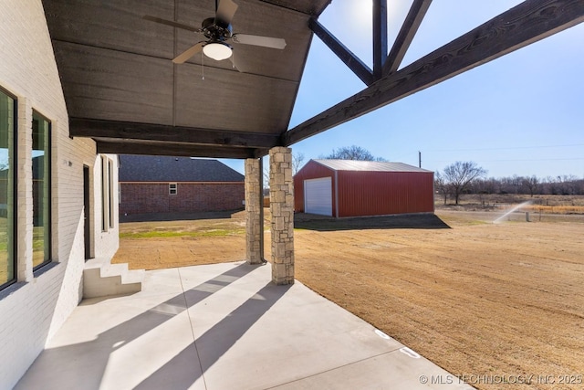 view of patio / terrace with ceiling fan, an outdoor structure, and a garage