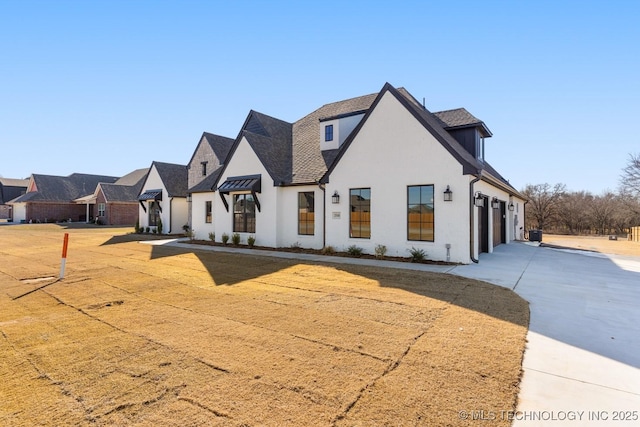 view of front of home featuring concrete driveway and stucco siding