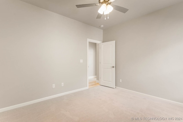 spare room with light carpet and ceiling fan