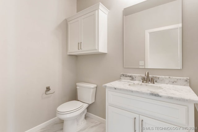 bathroom featuring toilet and vanity