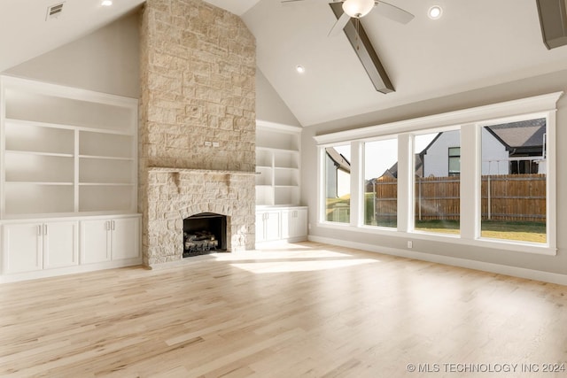 unfurnished living room featuring a fireplace, ceiling fan, light hardwood / wood-style flooring, and high vaulted ceiling