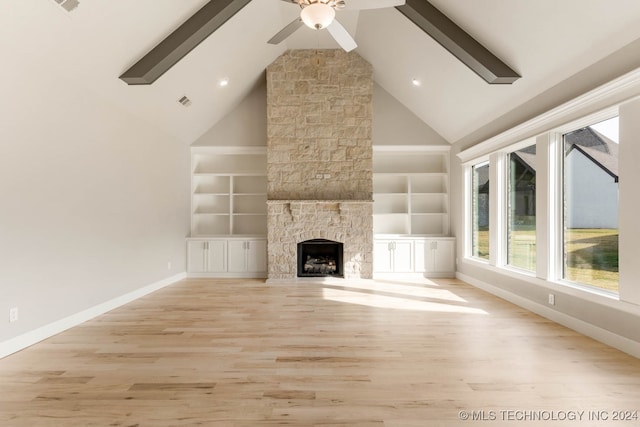 unfurnished living room featuring high vaulted ceiling, light hardwood / wood-style floors, and a fireplace